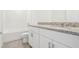 Bathroom with granite countertop, single vanity, and tub at 2462 Leeds St, Haines City, FL 33844