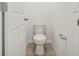 Small half bathroom with toilet and pedestal sink at 2462 Leeds St, Haines City, FL 33844
