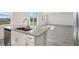 Kitchen island with double sink and view into the living area at 2462 Leeds St, Haines City, FL 33844