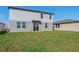 Two-story home with gray siding and a grassy backyard at 2462 Leeds St, Haines City, FL 33844