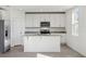Modern kitchen featuring white cabinets, granite countertops, and island at 2462 Leeds St, Haines City, FL 33844