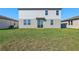 Two-story home with gray siding and a grassy backyard at 2462 Leeds St, Haines City, FL 33844