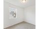 Bright bedroom with carpeted floor and a large window offering an outdoor view at 2342 White Tail St, Davenport, FL 33837