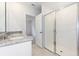 Bathroom with double vanity, granite countertop and a walk-in shower at 2342 White Tail St, Davenport, FL 33837