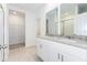 Double vanity bathroom with granite countertop and access to a walk in closet at 2342 White Tail St, Davenport, FL 33837
