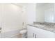 Bathroom with a bathtub, toilet, and granite countertop vanity at 2342 White Tail St, Davenport, FL 33837
