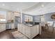 Open kitchen with island, granite countertops, and stainless steel appliances at 7481 Gathering Loop, Reunion, FL 34747