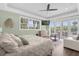 Main bedroom with a king-size bed, sitting area, and access to a private balcony at 7481 Gathering Loop, Reunion, FL 34747