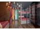 Themed bedroom with multiple beds, built-in bookshelves, and a chandelier at 7481 Gathering Loop, Reunion, FL 34747