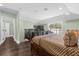 Spacious main bedroom with a large bed, plenty of natural light, and access to a private balcony at 7481 Gathering Loop, Reunion, FL 34747