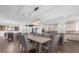 Open concept living and dining area with hardwood floors and modern lighting at 7481 Gathering Loop, Reunion, FL 34747