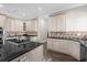 Well-equipped kitchen featuring white cabinets and granite countertops at 7481 Gathering Loop, Reunion, FL 34747