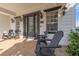 Front porch with black Adirondack chairs and double door entry at 7481 Gathering Loop, Reunion, FL 34747