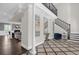 Bright entry showcasing a view into the living room and grand staircase at 7481 Gathering Loop, Reunion, FL 34747