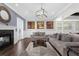 Open living area with two sofas, a fireplace, and hardwood floors at 7481 Gathering Loop, Reunion, FL 34747