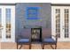 Outdoor patio with fireplace, and two rocking chairs at 7481 Gathering Loop, Reunion, FL 34747