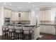 Modern kitchen with white cabinets, granite countertops, and stainless steel appliances at 7481 Gathering Loop, Reunion, FL 34747