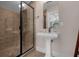 Clean bathroom with pedestal sink, shower, and modern fixtures at 7481 Gathering Loop, Reunion, FL 34747