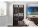 Home bar with custom cabinetry, wine storage, and a large flat-screen TV at 7481 Gathering Loop, Reunion, FL 34747