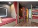 Themed bedroom with multiple beds, built-in bookshelves, and a chandelier at 7481 Gathering Loop, Reunion, FL 34747