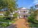 Two story home with covered porch and landscaping at 7481 Gathering Loop, Reunion, FL 34747