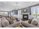 Comfortable living room featuring a fireplace, two sofas, and a large window at 7481 Gathering Loop, Reunion, FL 34747