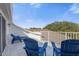 Private balcony with rocking chairs and lounge chairs, offering scenic views at 7481 Gathering Loop, Reunion, FL 34747