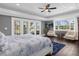 Main bedroom with a king bed, access to private balcony, and views of the golf course at 7481 Gathering Loop, Reunion, FL 34747