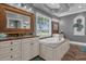 Luxurious bathroom with double vanities, large soaking tub, and marble flooring at 7481 Gathering Loop, Reunion, FL 34747