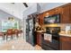 Well-equipped kitchen with dark wood cabinets and black appliances at 2713 Chatham Cir, Kissimmee, FL 34746