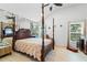 Main bedroom with four-poster bed and wood floors at 2713 Chatham Cir, Kissimmee, FL 34746