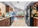 Kitchen with dark wood cabinets, black appliances, and adjacent dining area at 2713 Chatham Cir, Kissimmee, FL 34746