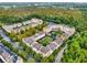 Aerial view showcasing apartment buildings in a wooded setting at 1220 Ironsmith Dr # 101, Celebration, FL 34747