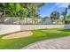 Landscaped backyard featuring a putting green and sand trap at 238 E Lakeshore Dr, Clermont, FL 34711
