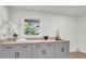 Bright laundry room with gray cabinets and a butcher block countertop at 238 E Lakeshore Dr, Clermont, FL 34711