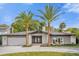 Stunning ranch home with circular driveway and palm trees at 238 E Lakeshore Dr, Clermont, FL 34711