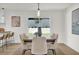 Modern dining room with a large wooden table and access to the backyard at 238 E Lakeshore Dr, Clermont, FL 34711