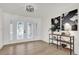 Bright entryway with hardwood floors, a statement light fixture, and an elegant console table at 238 E Lakeshore Dr, Clermont, FL 34711