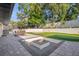 Outdoor oasis with a fire pit, patio, and putting green at 238 E Lakeshore Dr, Clermont, FL 34711