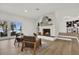 Spacious living room with a stone fireplace and water views at 238 E Lakeshore Dr, Clermont, FL 34711