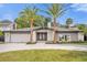 Stunning ranch home with circular driveway and palm trees at 238 E Lakeshore Dr, Clermont, FL 34711