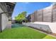 Artificial turf side yard with modern privacy fence and landscaping at 238 E Lakeshore Dr, Clermont, FL 34711