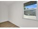 Bright bedroom with light wood flooring and a window offering backyard views at 238 E Lakeshore Dr, Clermont, FL 34711