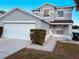 Two-story house with a double garage and well-manicured landscaping at 1347 Heather Lake Dr, Orlando, FL 32824