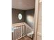 Upstairs hall with white railing and circular window at 1347 Heather Lake Dr, Orlando, FL 32824