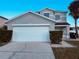 Two-story house with a double garage and well-manicured landscaping at 1347 Heather Lake Dr, Orlando, FL 32824