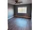 Bright bedroom featuring wood-look floors and a lake view at 1347 Heather Lake Dr, Orlando, FL 32824