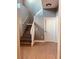 Modern staircase with wood-look flooring and white railing at 1347 Heather Lake Dr, Orlando, FL 32824