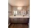 Modern bathroom with double sinks and gray cabinets at 1347 Heather Lake Dr, Orlando, FL 32824