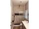 Spa-like bathroom with marble shower and gray vanity at 1347 Heather Lake Dr, Orlando, FL 32824